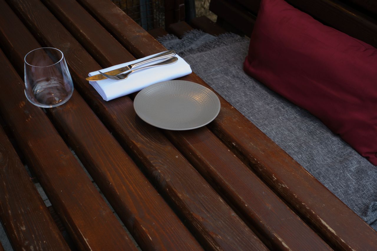 Cozy outdoor table setting at a rustic Dublin café with wood texture and simple décor.