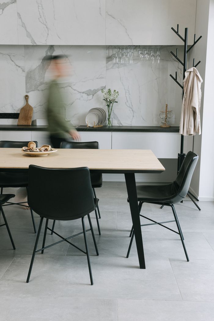 A stylish dining area featuring minimalist design and marble accents.